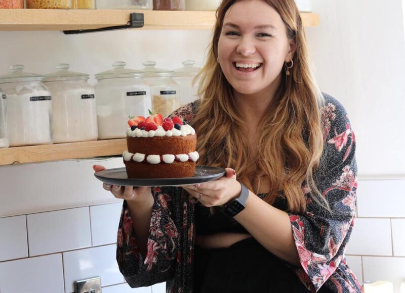 Violet holds up a Victoria sponge cake